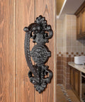 Heavy Duty 2 Pack 5.46 Inch Dark Brown Cast Iron Barn Door Handles Rustic Vintage Gate Fence Outdoor Garage Closet Cabinet Drawer Pulls Sturdy Rust Resistant Long Lasting With Retro Charm installed on a wooden door in a rustic kitchen setting.