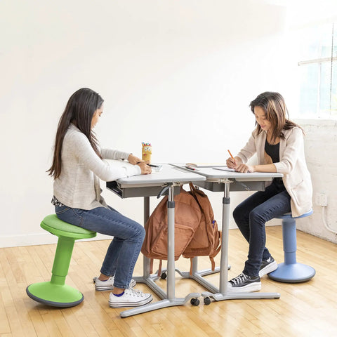 Two people sitting on Sitwell Wobble Stool With Cushion Adjustable Height Active Seating For Movement Perfect For Class Or Home Grassy Green