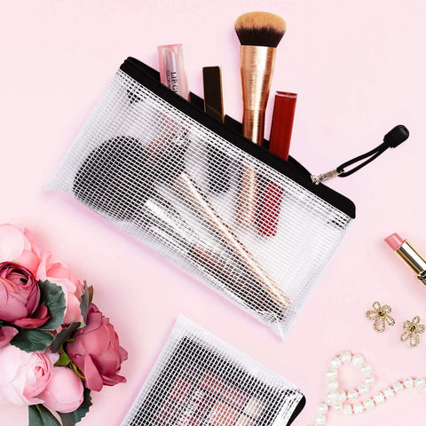 Six Pack Plastic Zipper Pencil Pouches Set Waterproof And Tear Resistant Document Folders A6 Size Zipper Pouches displayed with makeup brushes and accessories.