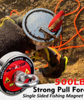 MUTUACTOR fishing magnet kit: round neodymium magnet with orange rope held by gloved hand