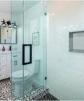 Bathroom with 12 By 12 Inch Shower Niche In Brushed Nickel Stainless Steel, built into a tiled shower wall with glass door.