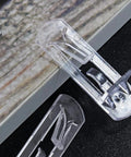 Close-up of clear self-locking plastic shelf pins for 16mm thick boards, part of a set of 20 locking cabinet pegs.
