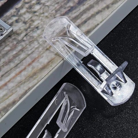 Close-up of clear self-locking plastic shelf pins for 16mm thick boards, part of a set of 20 locking cabinet pegs.