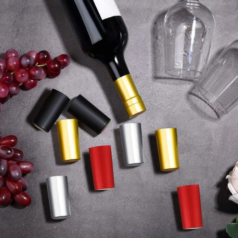Wine Sealer Caps Set for Bottles PVC Heat Shrink Capsules 200 Pcs Multi Color Black Red Gold Silver on table with wine bottle.