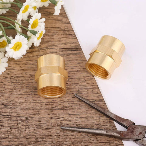 Heavy Duty Brass Pipe Fitting NPT Coupler One Half Inch By One Half Inch Hex Coupler Two Pack on wooden surface with flowers