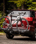 XTC2 Tilt Hitch Mount Bike Rack For Two Bikes With Platform Carrier on SUV in forest