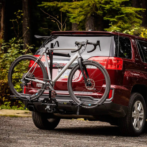 XTC2 Tilt Hitch Mount Bike Rack For Two Bikes With Platform Carrier on SUV in forest