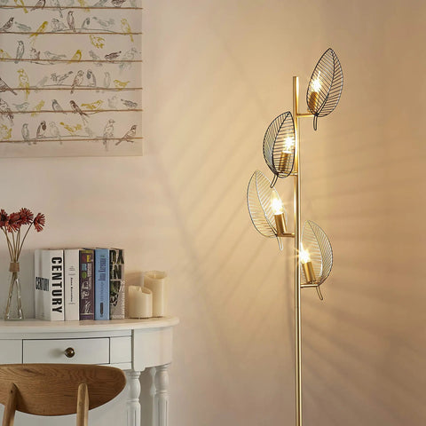 Industrial Gold Floor Lamp With 4 Black Leaf Shades in living room setting, modern tree style, lit reading light, includes 4 bulbs.