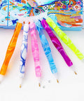 Colorful handmade resin diamond painting pen kit with glue clay and multiple tips for 5D DIY crafts, pink essentials shown on canvas