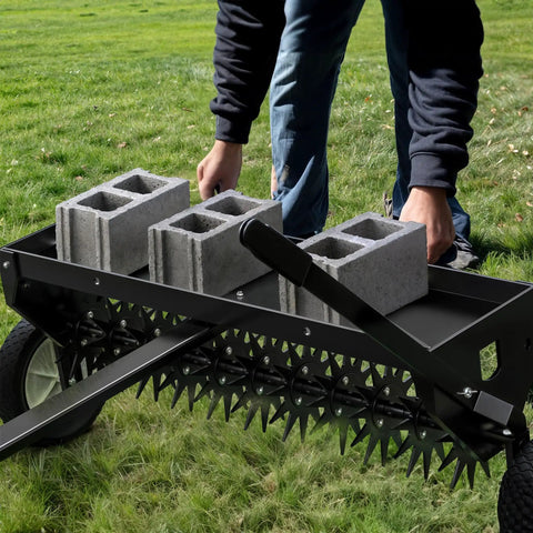 40 Inch Tow Behind Spike Aerator For Lawns With 11 Star Shaped Galvanized Plug Core Tines being adjusted by a person on grass