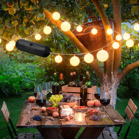 Garden party scene with table setting and 16 Pack Outdoor Extension Cord Safety Capsule Protectors for Holiday Lights, black color shown.