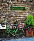 Mechanical Engineer Tin Sign 4x16 Inch Retro Metal Wall Decor above green bike with flower baskets against stone wall
