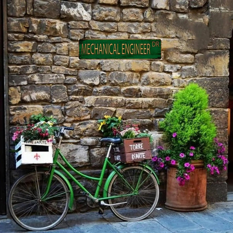 Mechanical Engineer Tin Sign 4x16 Inch Retro Metal Wall Decor above green bike with flower baskets against stone wall