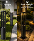 Modern Black LED Pathway Lights Sleek Cone Bollards illuminated at night along a garden walkway, featuring aluminum housing.