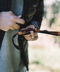 Close-up of hands setting up 10ft Heavy Duty Hammock Straps for Trees with Carabiners, orange loops, knot-free setup, durable gear