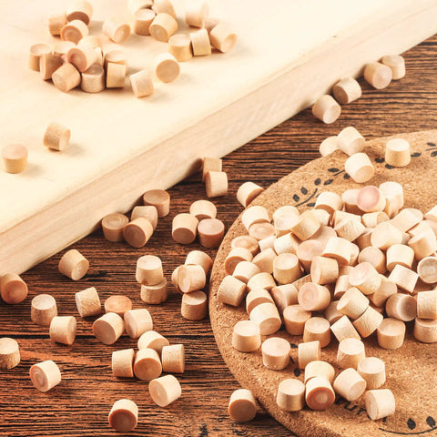 200 Piece Flat Head Wooden Screw Hole Plugs Three Eighths Inch Diameter One Quarter Inch Deep For Furniture Repair on wood surface