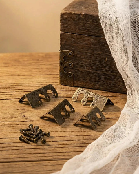 Solid Brass Corner Protectors Bronze Finish 14 Pack Heavy Duty Baseboard Edge Guards on wooden surface with screws.