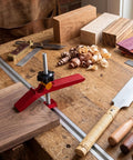 Heavy Duty Adjustable T Track Clamp With Micro Fine Tuning For Woodworking securing a wood board on a workbench.