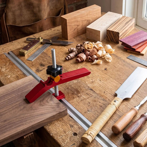 Heavy Duty Adjustable T Track Clamp With Micro Fine Tuning For Woodworking securing a wood board on a workbench.