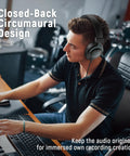 Man using studio monitor headphones for recording with 50mm drivers, focusing on music creation in a home studio.