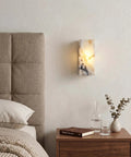 Marble Wall Sconce with Frosted Glass Globe and G4 LED (Rectangular) mounted above a bedside table in a cozy bedroom.