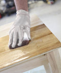 Hand using Twin Pack 4x5 White Terry Cloth Staining Pad with SuperTuff Sponge on wood surface for smooth stain application