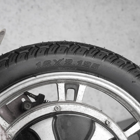 Close-up of Sixteen Inch Bike Tire With Inner Tube Set 16X2.125 for electric bicycles, showing tread pattern and size marking.