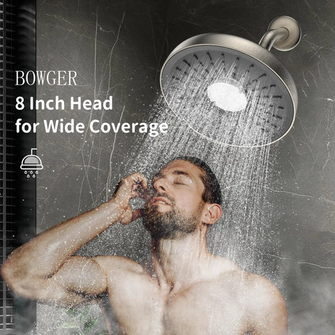 Chrome Fixed Showerhead With 135 Self Cleaning Silicone Nozzles, 1.75 GPM Flow showering water over a man