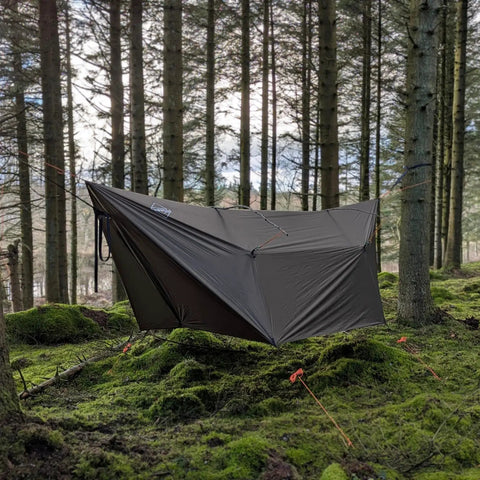 12 By 10 Ft Ultralight Camping Hammock Tarp Rainfly With Doors set up in a mossy forest, showing silnylon ripstop material and design.