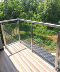 Hella Sturdy Gold Stainless Steel Deck Railing Posts For 10Mm To 12Mm Glass Panels Chef Kiss Finish on balcony overlooking green landscape.