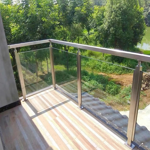 Hella Sturdy Gold Stainless Steel Deck Railing Posts For 10Mm To 12Mm Glass Panels Chef Kiss Finish on balcony overlooking green landscape.