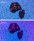 Dope Dual 365nm 395nm UV Flashlight illuminates rocks showing fluorescence under UV light for mineral detection.