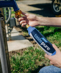 Person connecting TastePure RV Water Filter Inline System With Flexible Hose Protector Six Step Filtration GAC And KDF to outdoor spigot