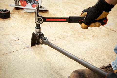 Using 30 Inch Indexing Flat Pry Bar With 180 Degree Head And 15 Lock Positions on wooden floor, dual material grip visible