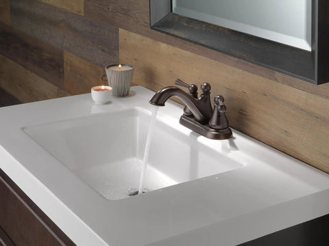 Haywood Venetian Bronze Centerset Two Handle Bathroom Faucet With Drain Assembly flowing in modern bathroom sink