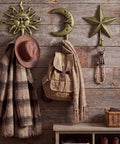 Three Pack Vintage Cast Iron Wall Hooks In Dark Gold Antique Finish Featuring Sun Moon Star Celestial Shapes With Included Screws on wooden wall.