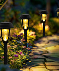 Eight Pack Solar Pathway Lights Waterproof Outdoor Garden Yard Landscape Walkway Driveway With Auto On Off And Energy Saving Warm White Glow Weather Resistant Easy Setup illuminating a garden path at night.