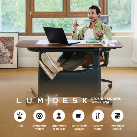Colamy 55x28 Inch Electric Standing Desk Dual Motor Sit Stand Workstation with walnut finish and ergonomic footrest in a modern office setting.