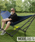 Two Person Hammock With Stand Foldable Outdoor Hammock Set 600 lb Capacity in use, Aegean color, in a green field