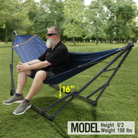Two Person Hammock With Stand Foldable Outdoor Hammock Set 600 lb Capacity in use, Aegean color, in a green field