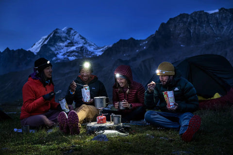 Campers enjoying meals with Ultralight Titanium Long Spoon For Backpacking And Camping, Durable Camp Utensil With Long Handle And Carabiner Loop