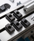 5 Pieces T Slot Nuts In 45 Steel With Black Oxide Finish For CNC Machine, Router Table And Drill Press Workholding And Clamping, Heavy Duty Secure Threaded Fasteners For Precision Fixtures And Fixturing. five black oxide T-slot nuts on machine table