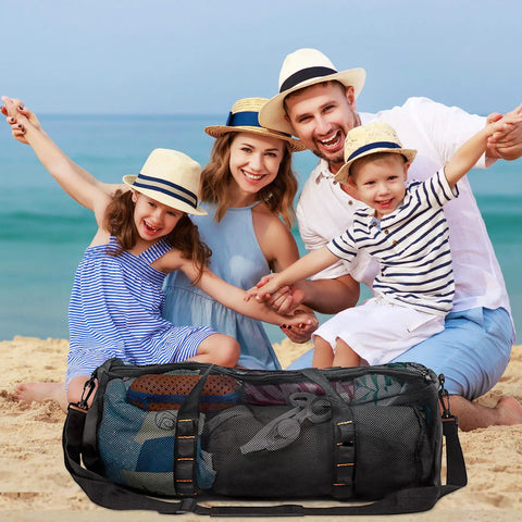 Family posing on beach with Large Mesh Dive Bag For Scuba Gear And Snorkeling Essentials in front, showing size and use.