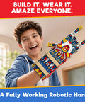Hands On Robotic Hand Kit For Kids Ages Eight To Thirteen, Wearable Cool Gripper Build Kit To Learn Engineering And Anatomy Through Play, DIY STEM Toy Gift For Birthday Fun And Creative Problem Solving. Boy wearing colorful robotic hand kit