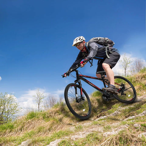Trail Ready 27.5 Inch Mountain Bike For Men And Women, 21 Speed Shifting, dual disc brakes, riding on grassy trail, sunny day