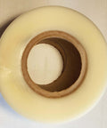 Top view of a roll of 4 Inch By Point Zero One Five Inch By 100 Foot Urethane Die Protection Film For Press Brake Protects Stainless Steel