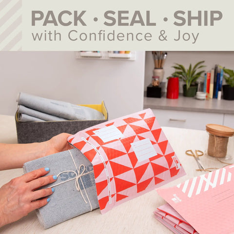 Person packing a parcel in red poly bubble mailer Size 2 small 8.5 x 11 inch pack of 4 on a desk.