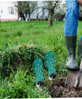Person using Eight Piece Lawn Aerator Shoes With Solid Metal Straps For Easy Assembly And Soil Aeration On Lawns Gardens And Patios