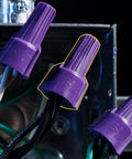 Close-up of purple Al/Cu twist on wire connector nuts for aluminum to copper and copper to copper, 18 AWG to 10 AWG, in use.