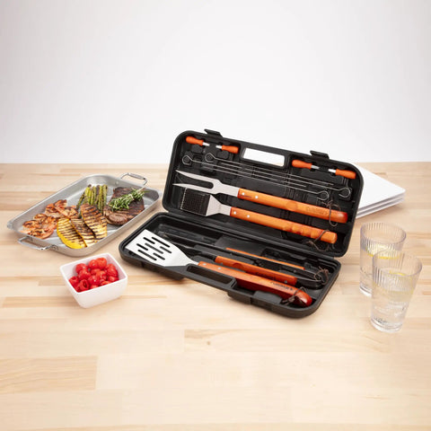 Open compact case showing 13 Piece Wooden Handle Grill Tools Set With Stainless Steel Spatula, Fork, Tongs, near grilled food.